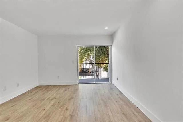 unfurnished room with light wood-type flooring