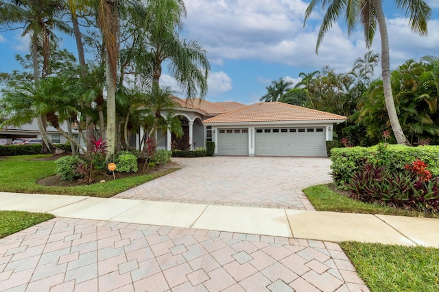 mediterranean / spanish home with a garage