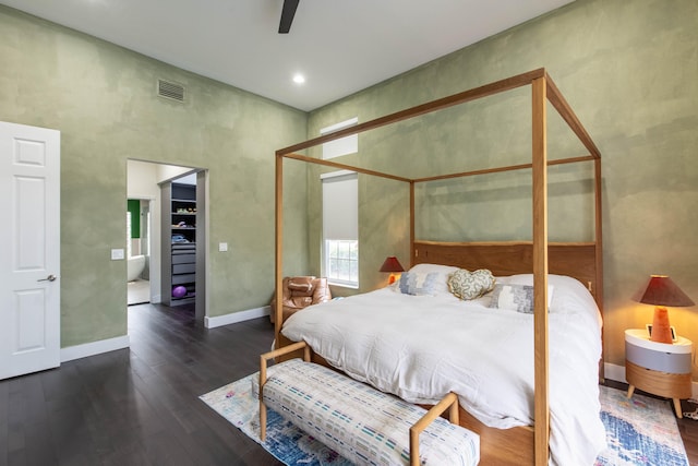 bedroom with ceiling fan and dark wood-type flooring