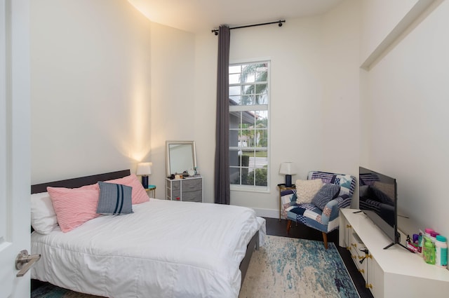 bedroom with wood-type flooring and multiple windows