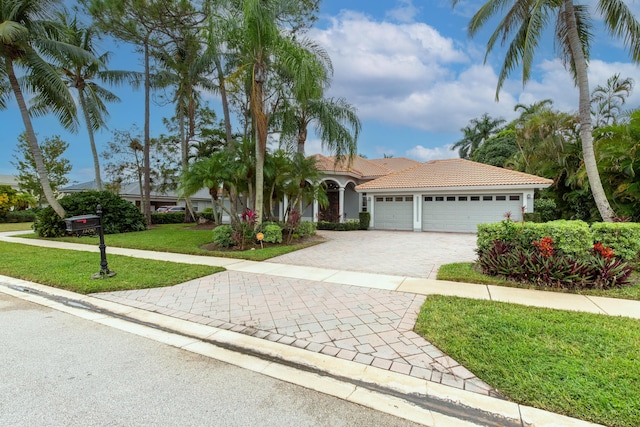 view of front of house featuring a garage and a front lawn