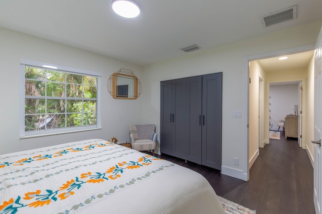 bedroom with dark hardwood / wood-style flooring