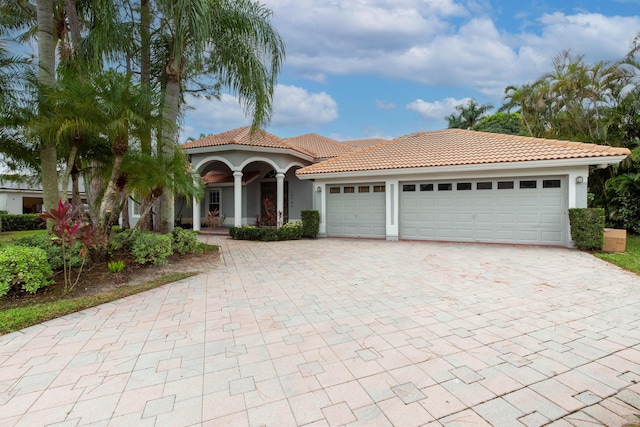 mediterranean / spanish-style home featuring a garage