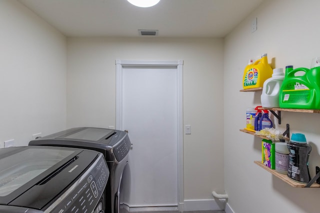 clothes washing area featuring washer and clothes dryer