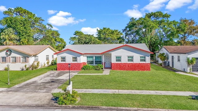 single story home with central AC unit and a front yard