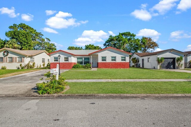 single story home featuring a garage and a front yard