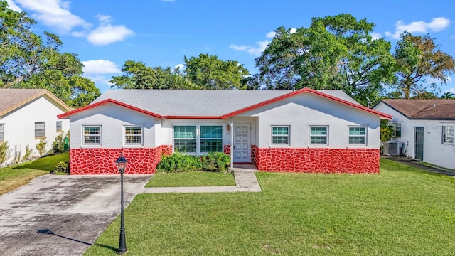 ranch-style home with central AC unit and a front lawn