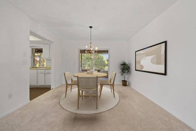 carpeted dining area with a chandelier