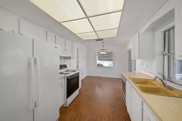 kitchen with sink, white appliances, dark wood-type flooring, white cabinets, and decorative light fixtures