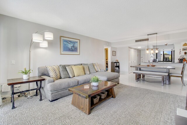 living room featuring light tile patterned floors and a textured ceiling