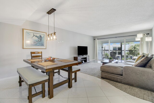 tiled dining area featuring a textured ceiling