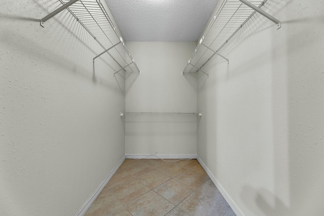 walk in closet featuring light tile patterned floors