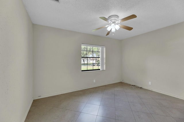 unfurnished room with light tile patterned floors, a textured ceiling, and ceiling fan