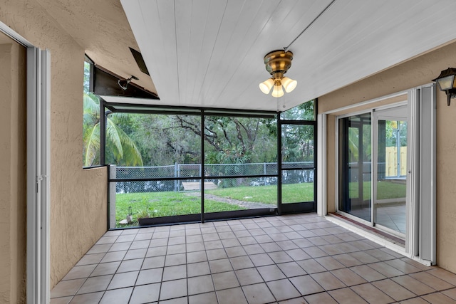 unfurnished sunroom featuring lofted ceiling and wood ceiling