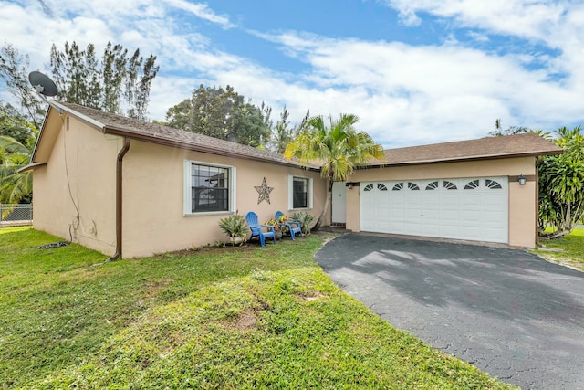 single story home with a garage and a front lawn