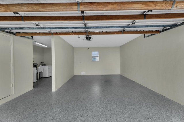 garage featuring washer and clothes dryer and a garage door opener