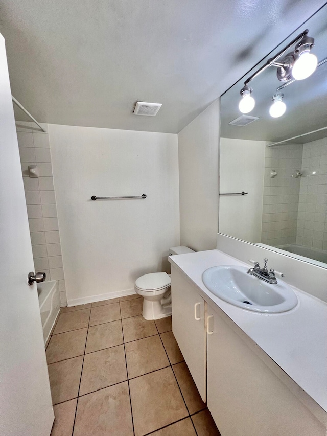 full bathroom featuring tile patterned flooring, vanity, toilet, and tiled shower / bath