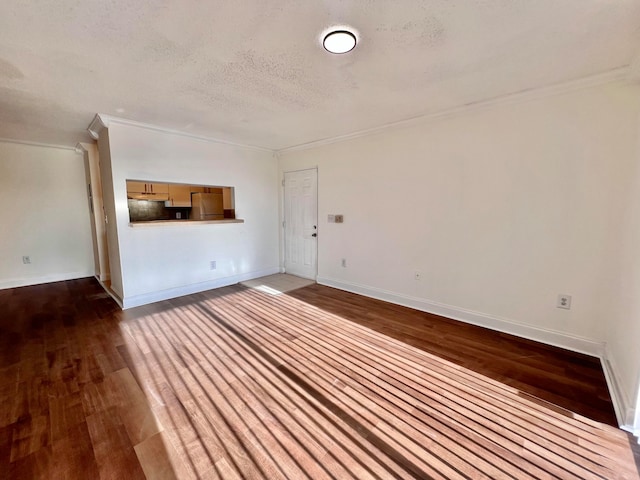 unfurnished living room featuring hardwood / wood-style floors, ornamental molding, and a textured ceiling