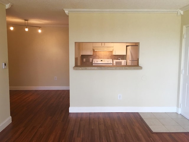 unfurnished living room with a textured ceiling, dark hardwood / wood-style floors, and ornamental molding