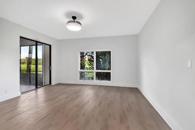 empty room featuring wood finished floors and baseboards