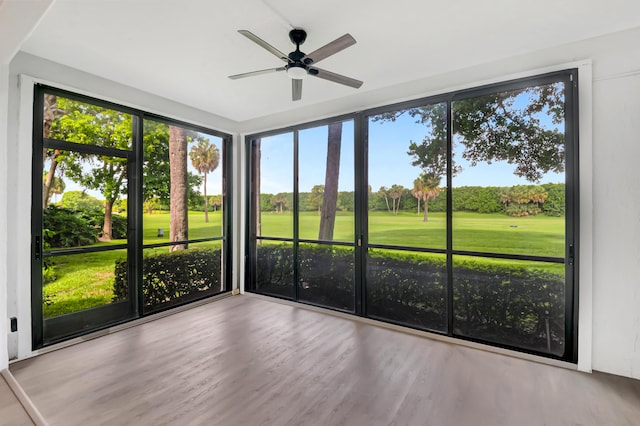 unfurnished sunroom featuring ceiling fan