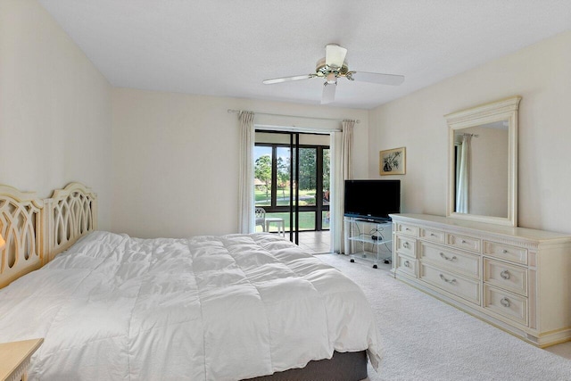 bedroom with ceiling fan, access to exterior, light colored carpet, and a textured ceiling