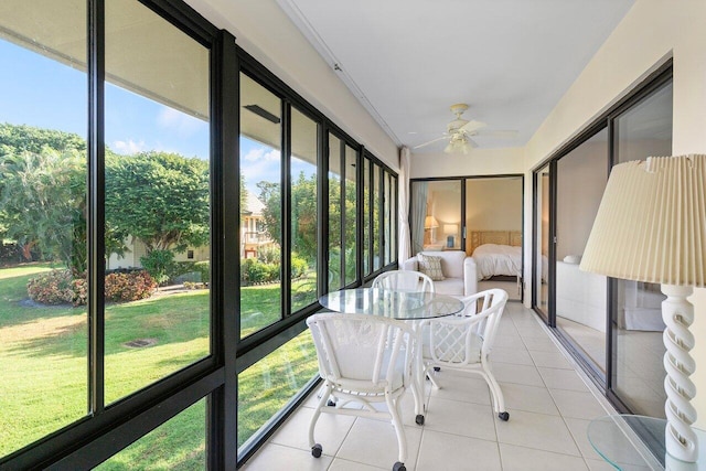 unfurnished sunroom with ceiling fan and plenty of natural light