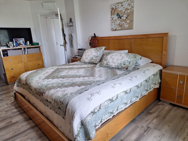 bedroom with wood-type flooring