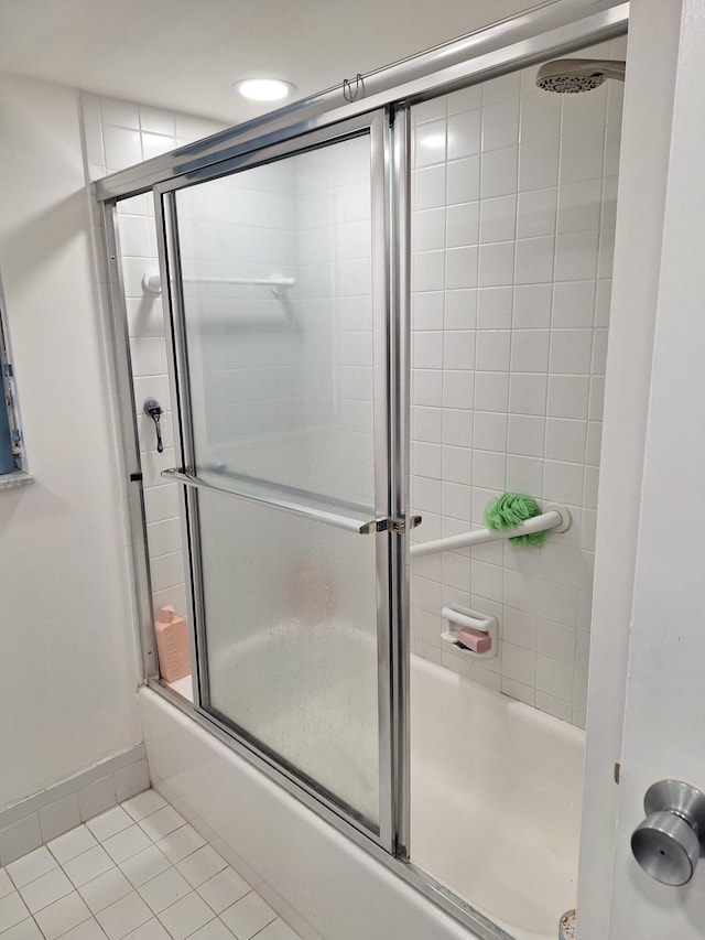 bathroom with shower / bath combination with glass door and tile patterned floors