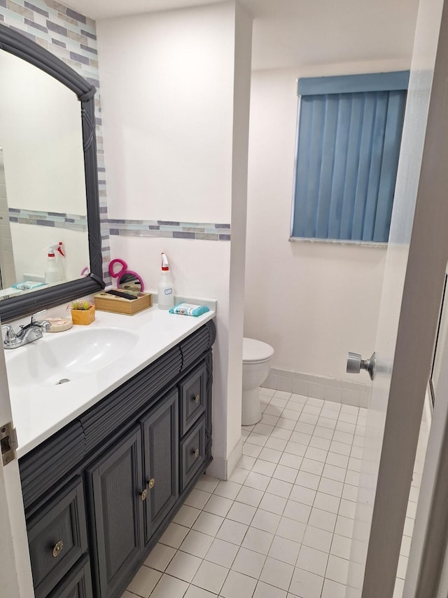 bathroom with tile patterned floors, vanity, and toilet