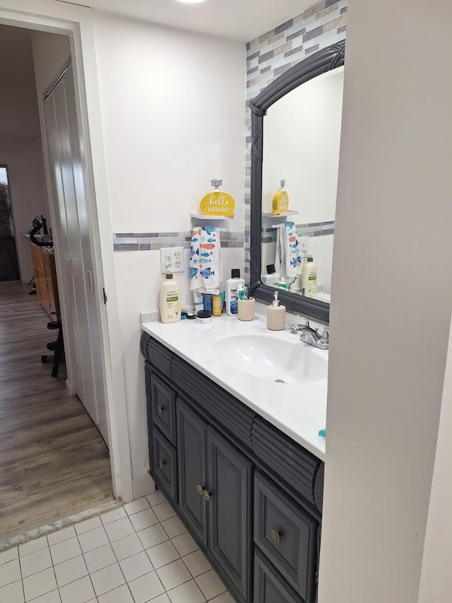 bathroom featuring vanity, tile walls, and hardwood / wood-style flooring