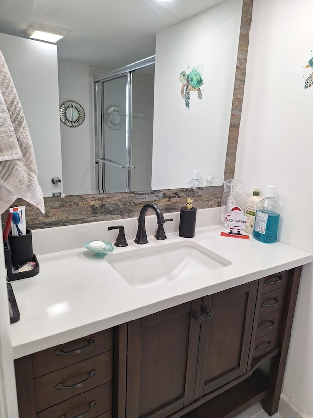 bathroom featuring vanity and a shower with shower door