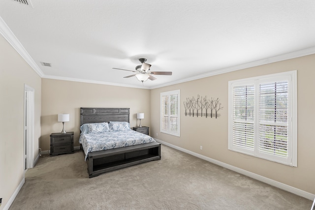 carpeted bedroom featuring ceiling fan and ornamental molding