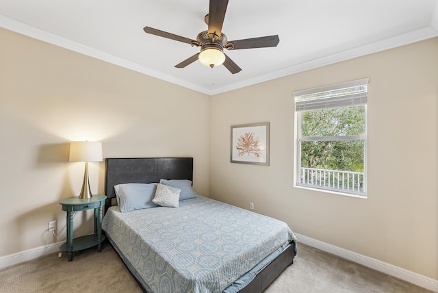 carpeted bedroom with ceiling fan and ornamental molding