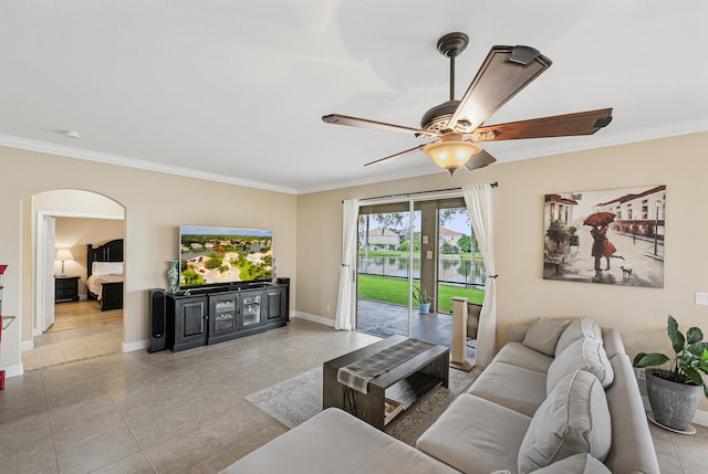 living room featuring ceiling fan, ornamental molding, and light tile patterned floors