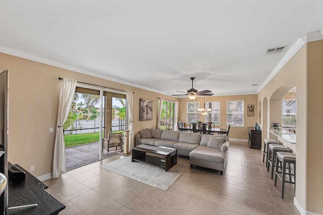 tiled living room with crown molding and ceiling fan