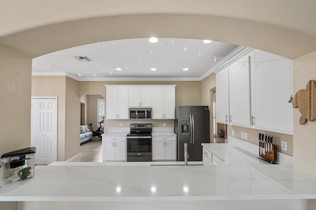 kitchen featuring white cabinetry, light stone countertops, and appliances with stainless steel finishes