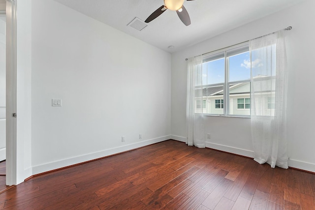 spare room featuring ceiling fan and dark wood-type flooring