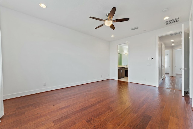 empty room with ceiling fan and dark wood-type flooring