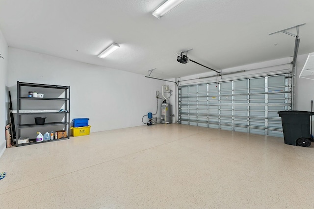 garage with a garage door opener and water heater