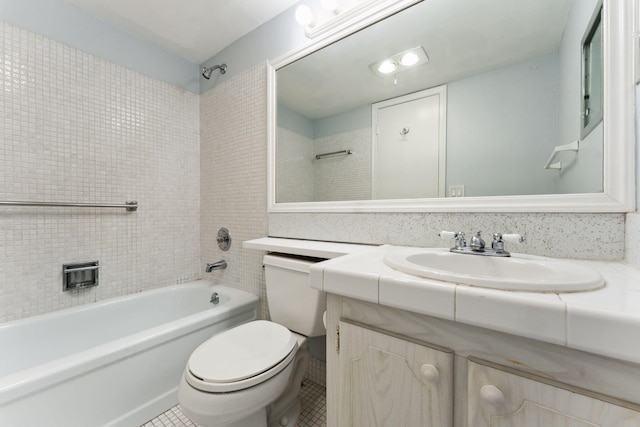 full bathroom featuring tile patterned flooring, vanity, tiled shower / bath combo, and toilet