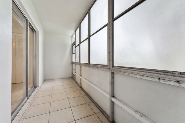 corridor with light tile patterned floors