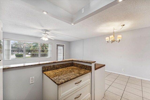 kitchen with white appliances, white cabinets, hanging light fixtures, a textured ceiling, and a wall mounted AC