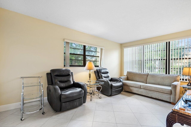 tiled living room featuring a textured ceiling