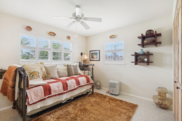 bedroom featuring multiple windows and ceiling fan