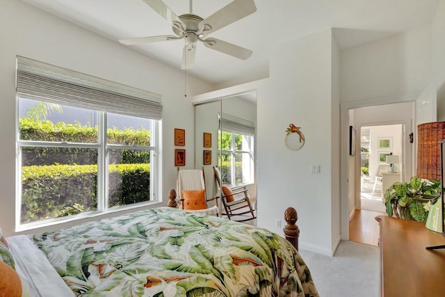 bedroom featuring light carpet, a closet, and ceiling fan