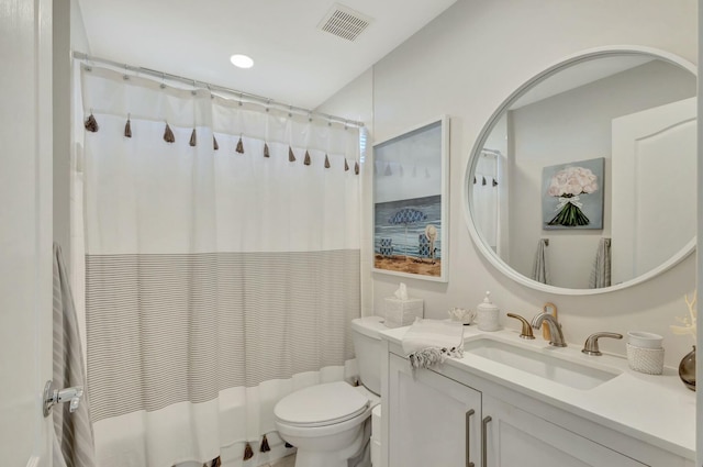 bathroom with a shower with shower curtain, vanity, and toilet