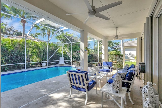 view of swimming pool with outdoor lounge area, a patio, glass enclosure, and ceiling fan