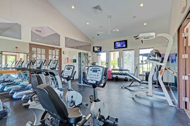 exercise room with ceiling fan, french doors, and high vaulted ceiling