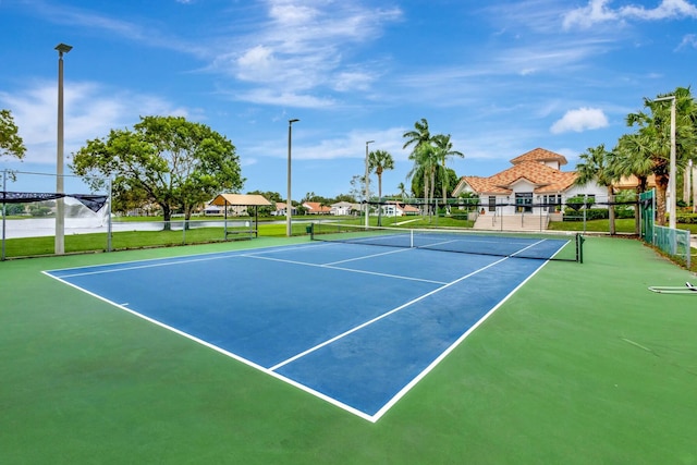 view of tennis court with basketball hoop